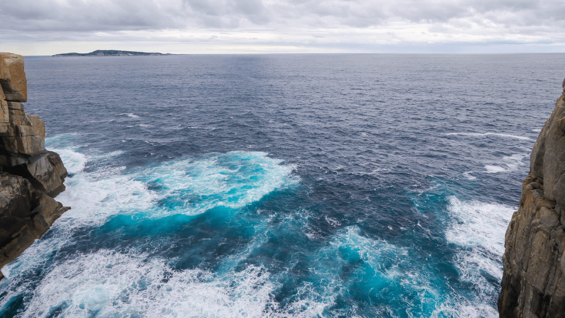 ocean waves crashing into cliffs