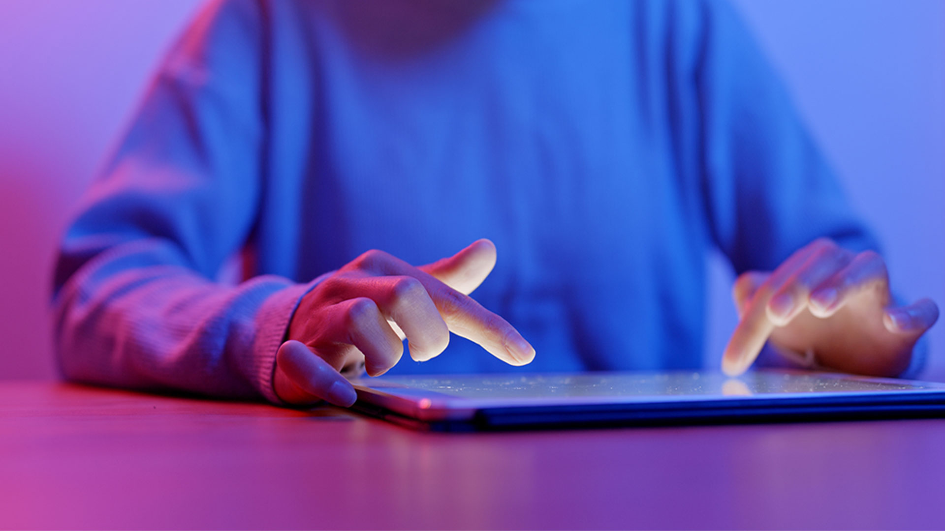 Woman using technology typing on tablet